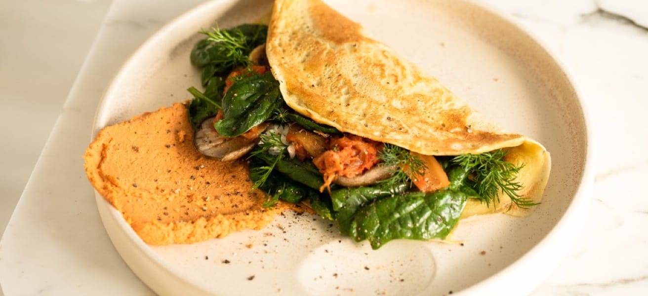 Omelette with beaten eggs, cheese, vegetables, and meat